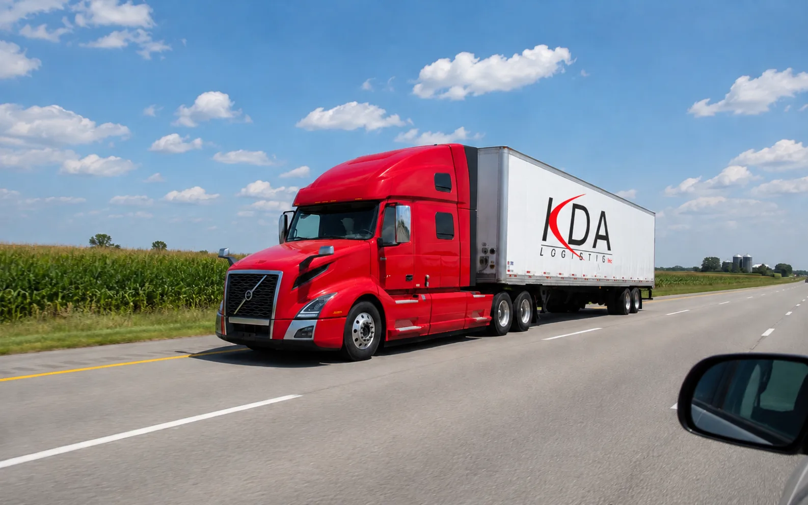 Dry van semi truck driving through Illinois farmland